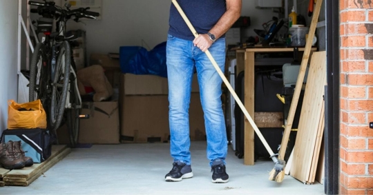 Man sweeping the garage floor